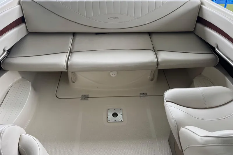 Slide: The Image of Interior seating of 2002 Maxum 2300 Premiere Edition boat, featuring beige upholstery. - 10