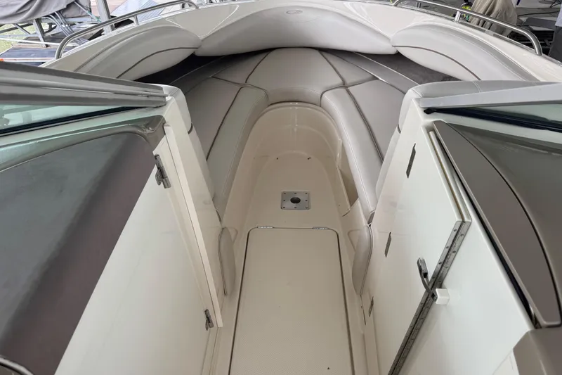 Slide: The Image of 2002 Maxum 2300 Premiere Edition boat interior with cushioned seating and storage compartments. - 11