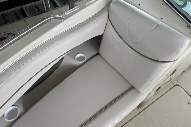 Slide: The Image of 2002 Maxum 2300 Premiere Edition boat interior with white seating and cup holders. - 12