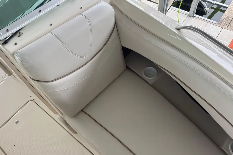Slide: The Image of 2002 Maxum 2300 Premiere Edition boat interior with beige seating and cup holder. - 13