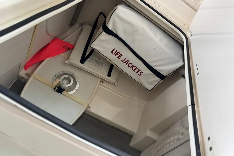 Slide: The Image of Storage compartment in a 2002 Maxum 2300 Premiere Edition boat with life jackets. - 15