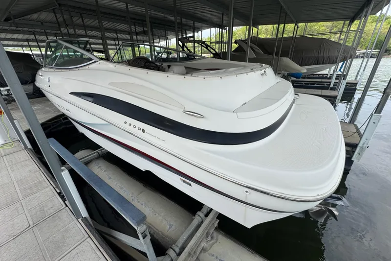 Slide: The Image of 2002 Maxum 2300 Premiere Edition boat docked in a covered marina. - 2
