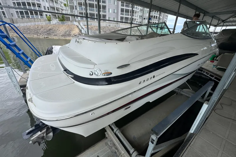 Slide: The Image of 2002 Maxum 2300 Premiere Edition boat docked in a covered marina. - 3