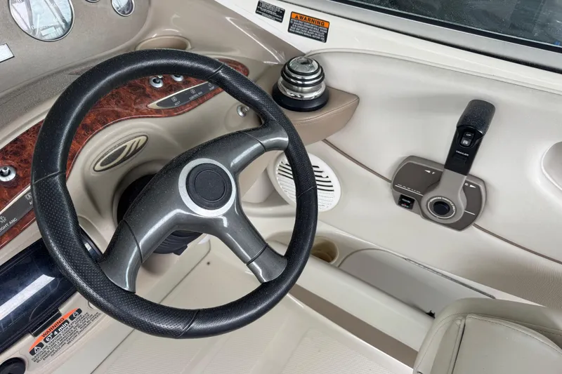 Slide: The Image of 2002 Maxum 2300 Premiere Edition boat dashboard with steering wheel and controls. - 8