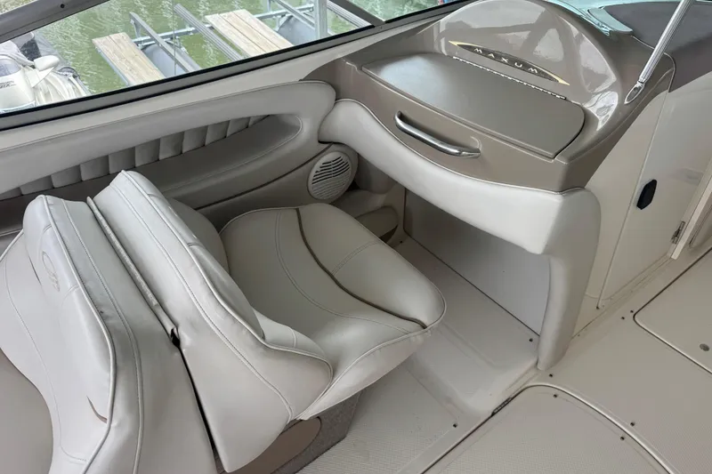 Slide: The Image of Interior of 2002 Maxum 2300 Premiere Edition boat with beige seating and dashboard. - 9