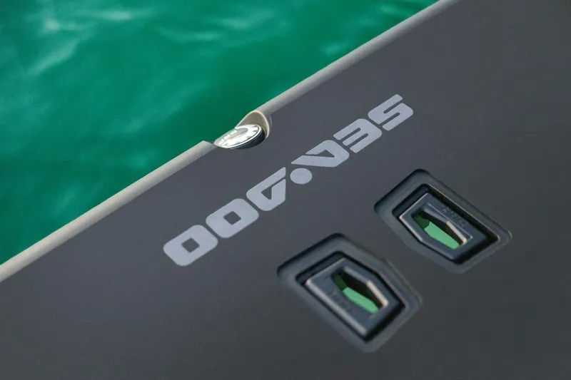 Slide: The Image of 2026 Sea-Doo Switch Cruise Limited 21 logo on sleek black surface near water. - 13