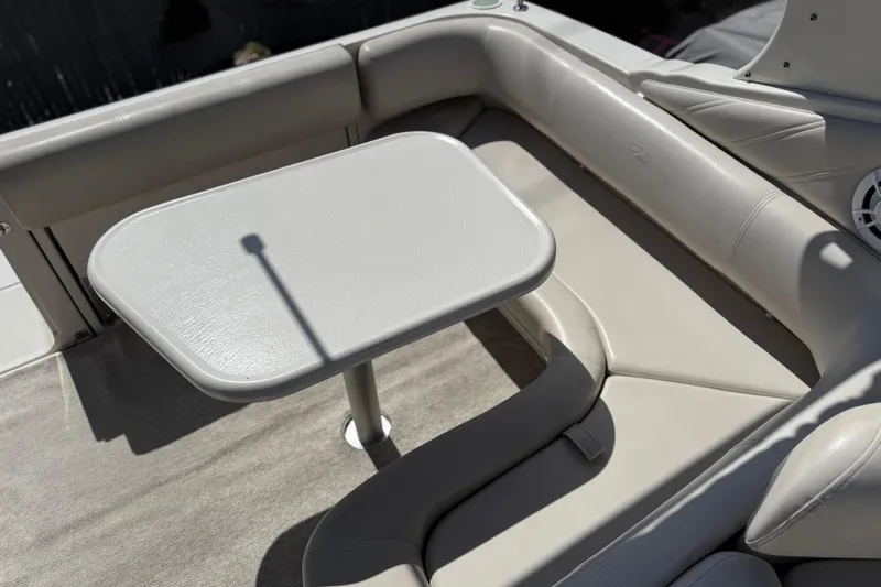 Slide: The Image of Cozy seating area on a 2000 Regal Commodore 2960 boat with a small table. - 10
