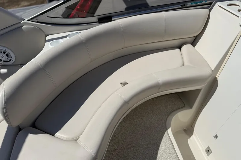 Slide: The Image of Cream leather seating on a 2000 Regal Commodore 2960 boat, featuring cup holders and speaker. - 11