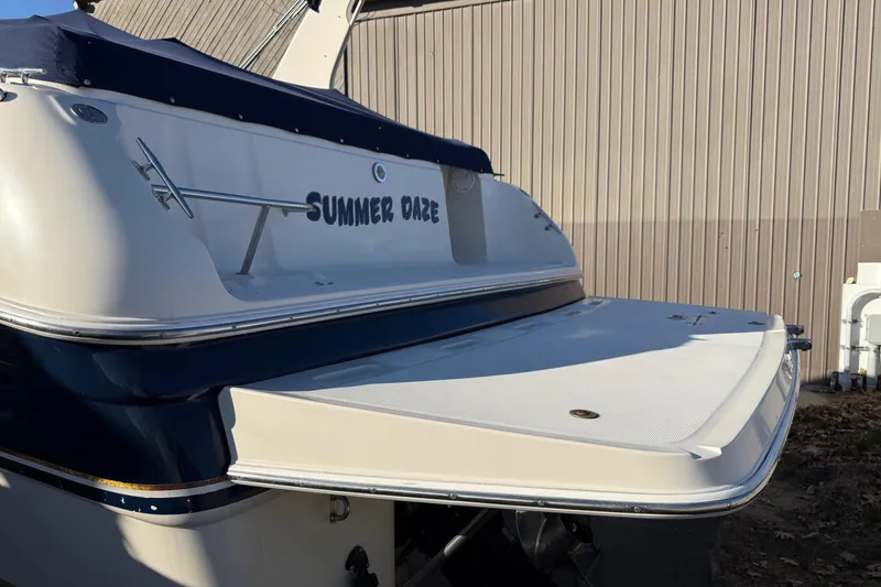 Slide: The Image of 2000 Regal Commodore 2960 boat named "Summer Daze" docked near a building. - 18