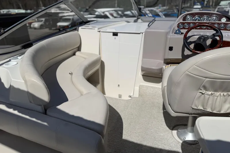 Slide: The Image of Interior of a 2000 Regal Commodore 2960 boat with beige seating and steering wheel. - 8