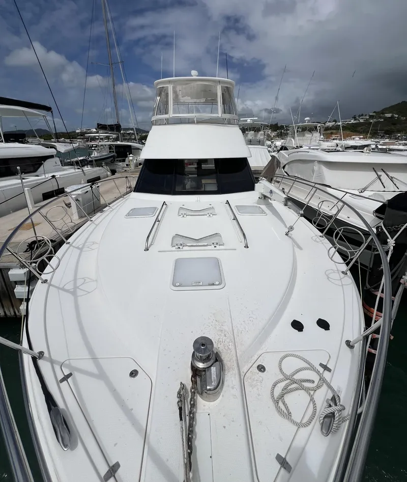 Slide: The Image of 2016 Riviera 45 OPEN yacht docked in marina, showcasing sleek design and spacious deck. - 1