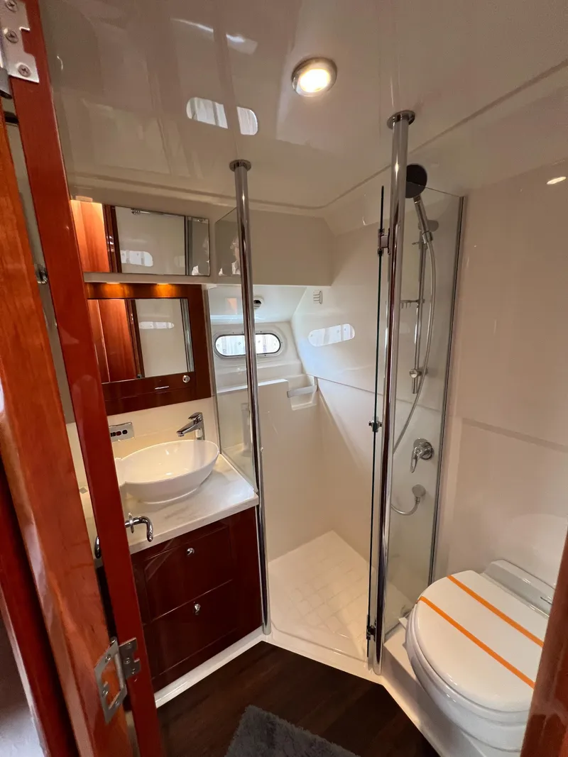 Slide: The Image of Luxurious bathroom in 2016 Riviera 45 OPEN yacht with modern fixtures and elegant wood accents. - 15