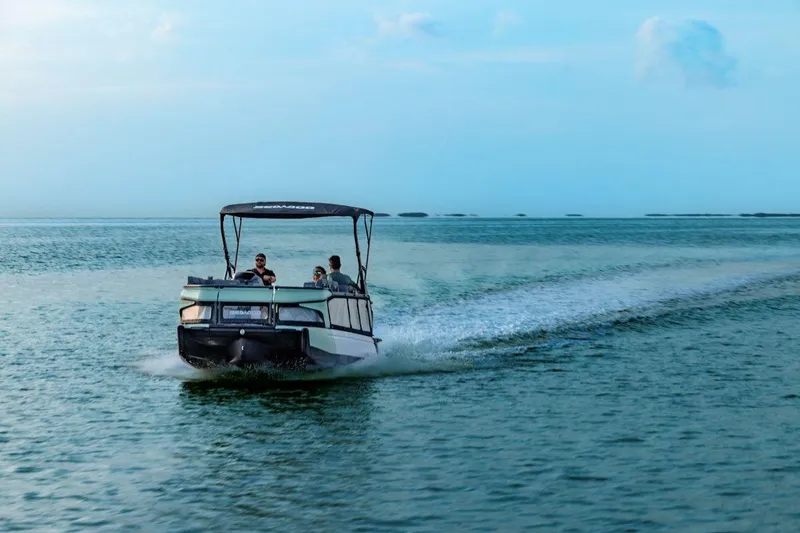 Slide: The Image of 2026 Sea-Doo Switch Fish 21 cruising on open water, rear view. - 9