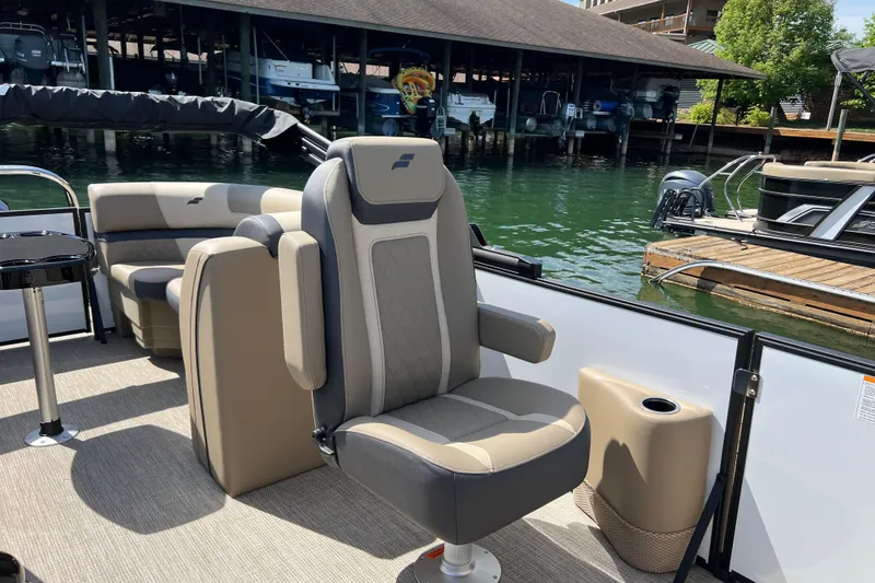 Slide: The Image of 2026 Starcraft EXS 3 R DH boat interior with comfortable seating at a marina. - 10