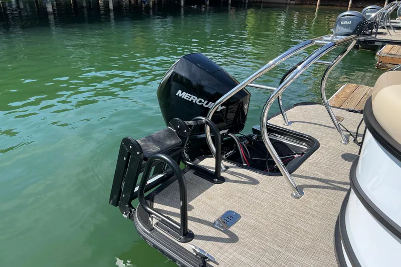Slide: The Image of 2026 Starcraft EXS 3 R DH boat with Mercury outboard motor on a calm lake. - 14