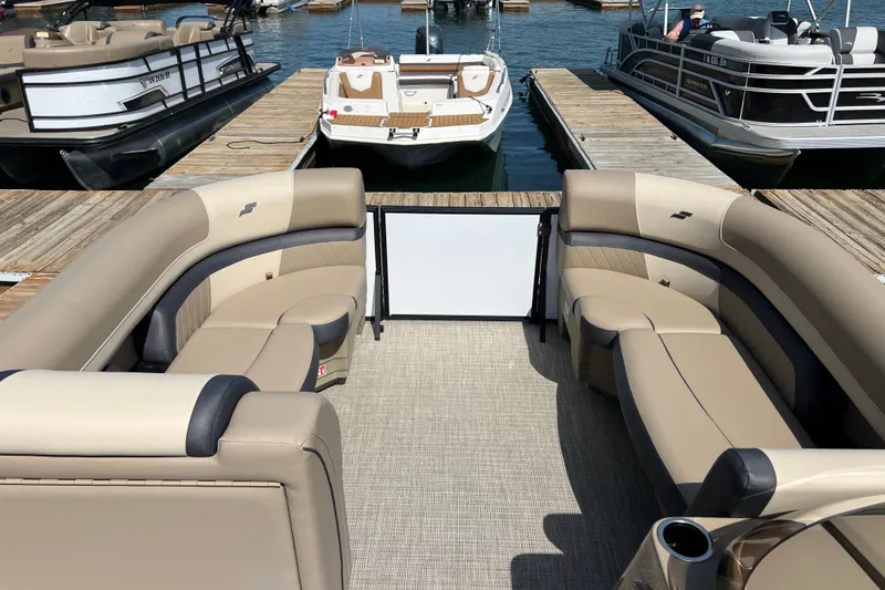 Slide: The Image of Luxurious 2026 Starcraft EXS 3 R DH pontoon boat interior at marina dock. - 3