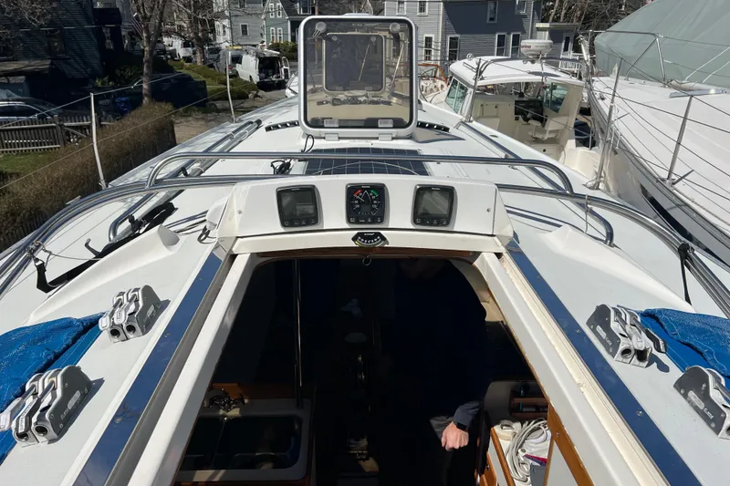 Slide: The Image of 1998 J Boats J/120 sailboat deck with open hatch and navigation instruments. - 10