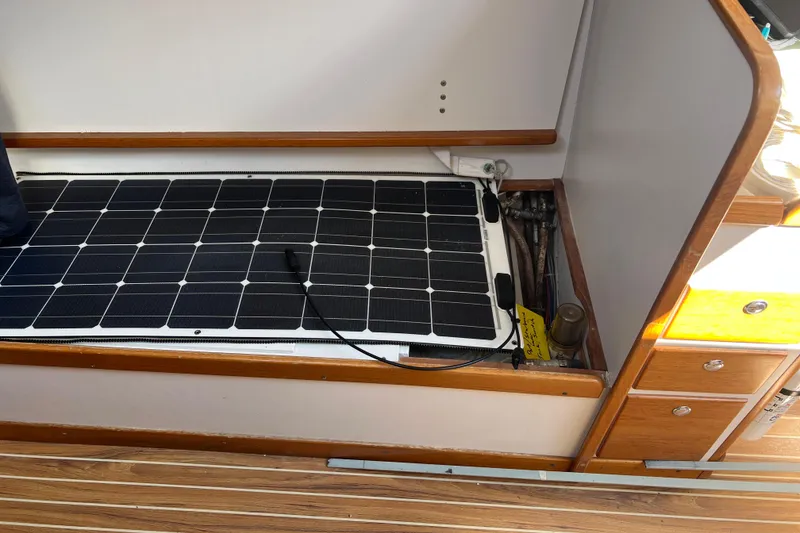 Slide: The Image of Interior of 1998 J Boats J/120 with solar panel installation on wooden flooring. - 6