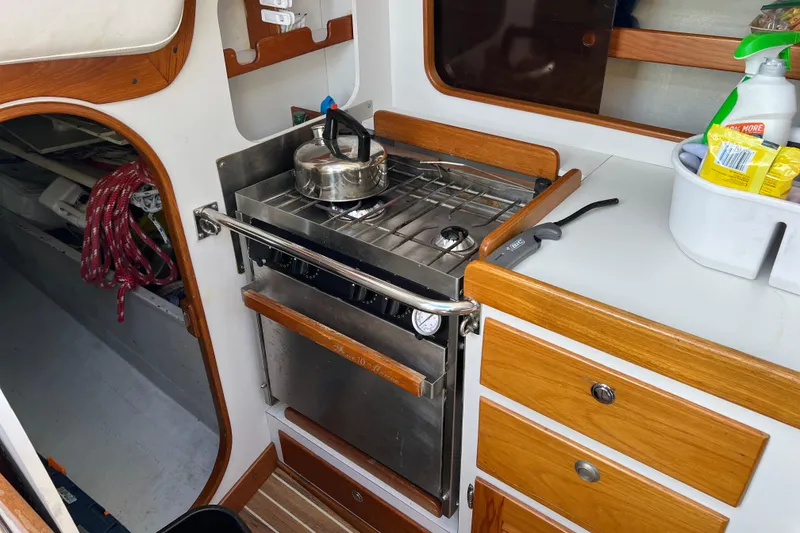 Slide: The Image of Galley of 1998 J Boats J/120 sailboat with stove, kettle, and storage. - 8