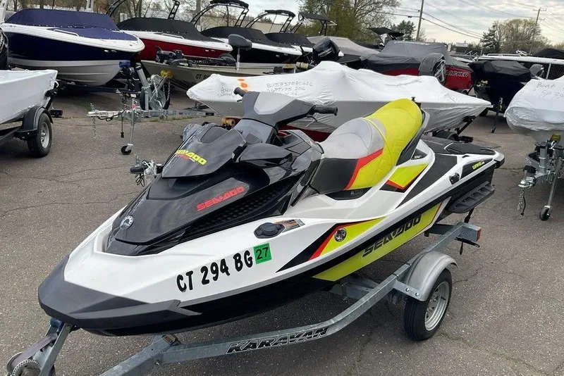 The Image of 2014 Sea-Doo Wake Pro 215 jet ski on trailer, parked among boats. - 0