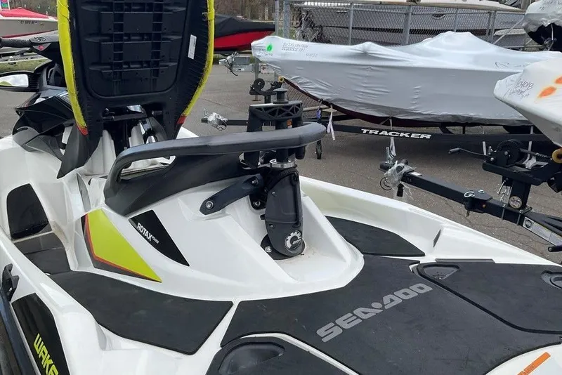 Slide: The Image of 2014 Sea-Doo Wake Pro 215 jet ski with Rotax engine, parked near covered boats. - 12