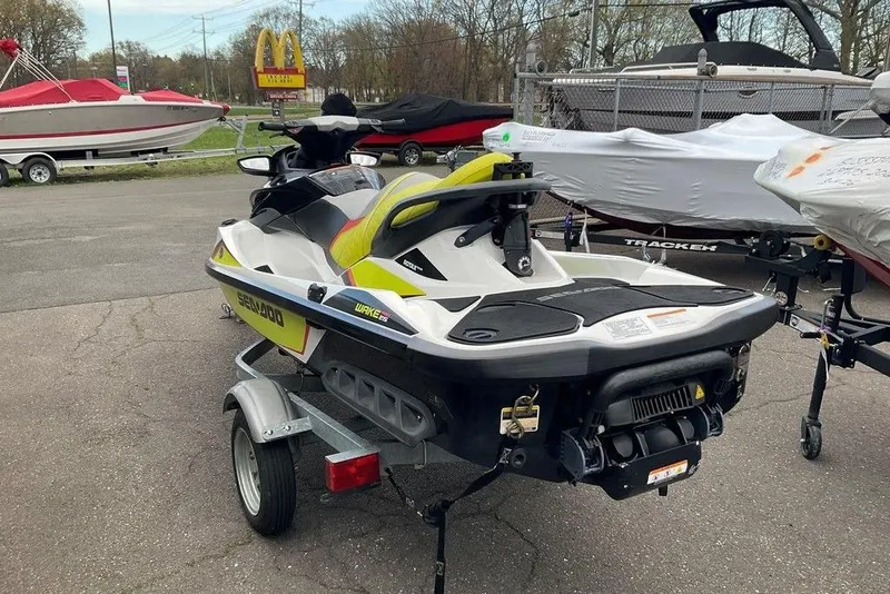 Slide: The Image of 2014 Sea-Doo Wake Pro 215 jet ski on trailer, parked outdoors. - 5