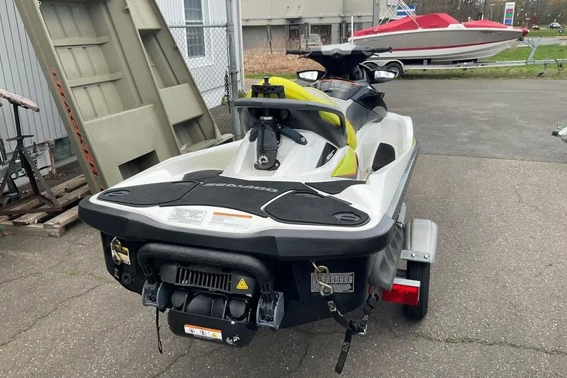 Slide: The Image of 2014 Sea-Doo Wake Pro 215 jet ski on trailer, parked outdoors. - 9