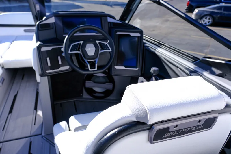 Slide: The Image of 2024 Supra SA 450 boat cockpit with modern steering and digital displays. - 15