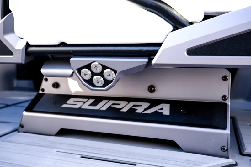 Slide: The Image of 2024 Supra SA 450 boat interior detail with control buttons and logo. - 23