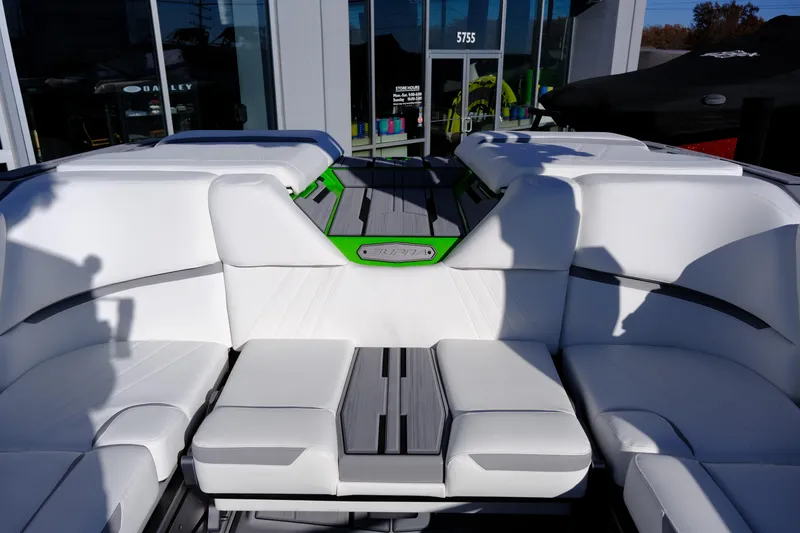 Slide: The Image of 2024 Supra SA 450 boat interior with white seating and green accents. - 24