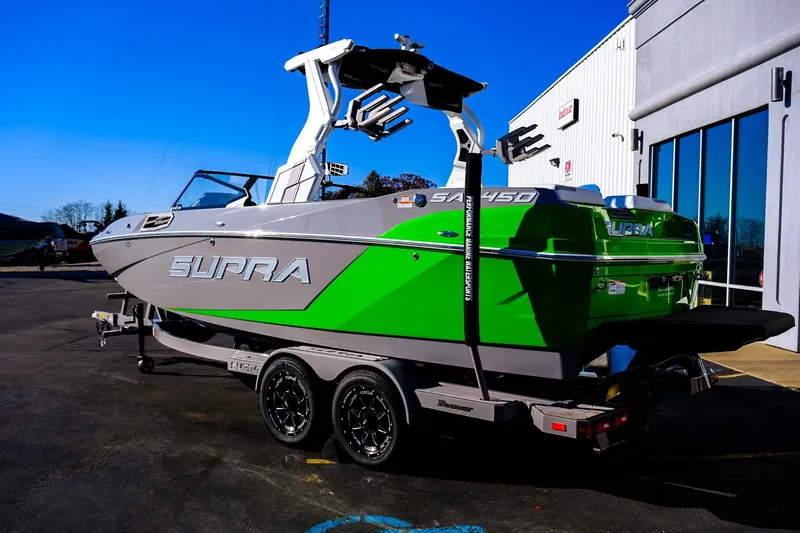Slide: The Image of 2024 Supra SA 450 boat with vibrant green and gray design on a trailer. - 25