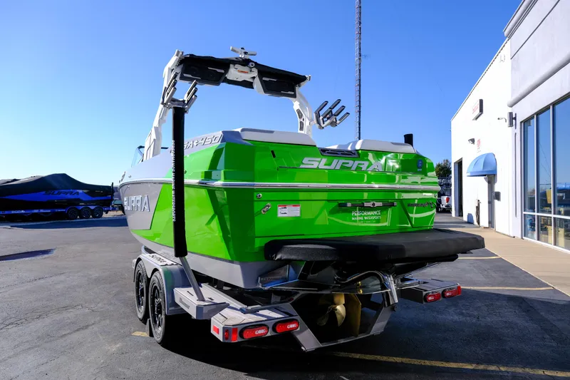 Slide: The Image of 2024 Supra SA 450 boat in vibrant green, parked outside a showroom. - 4
