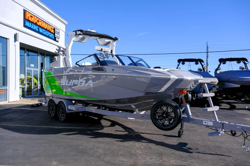 Slide: The Image of 2024 Supra SA 450 boat on trailer at Performance Marine Watersports dealership. - 6