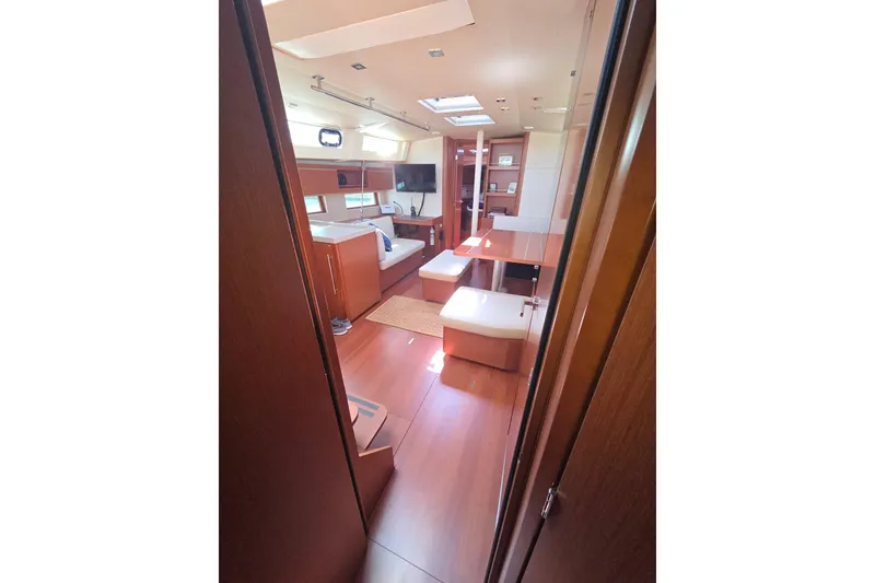 Slide: The Image of Interior of 2020 Beneteau Oceanis 46.1 yacht, featuring modern wood finish and seating area. - 10