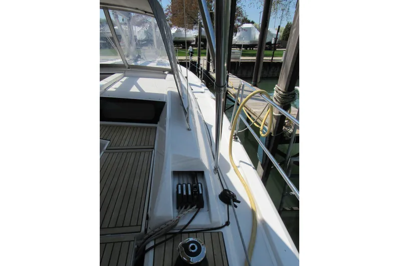 Slide: The Image of 2020 Beneteau Oceanis 46.1 sailboat deck with teak flooring and rigging details. - 16