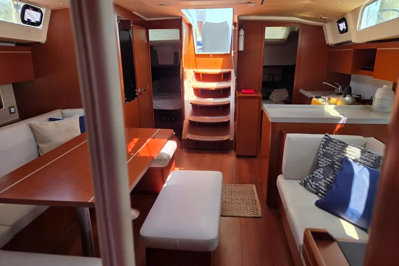 Slide: The Image of Interior of 2020 Beneteau Oceanis 46.1 yacht with modern wood finish and cozy seating. - 24