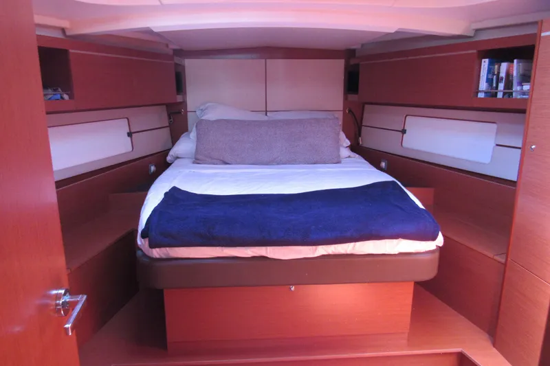 Slide: The Image of Interior cabin of 2020 Beneteau Oceanis 46.1 yacht with cozy bed and wooden finish. - 25