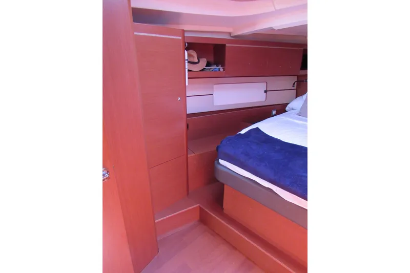 Slide: The Image of Interior cabin of 2020 Beneteau Oceanis 46.1 yacht, featuring a cozy bed and wooden furnishings. - 29