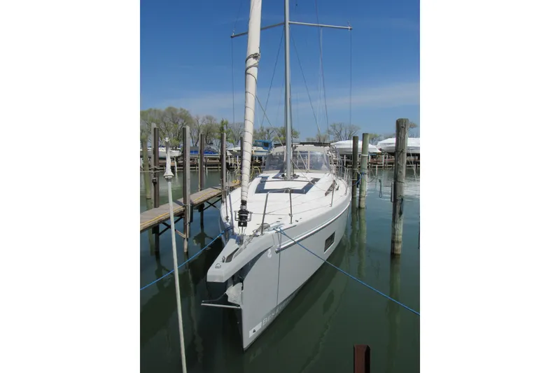 Slide: The Image of 2020 Beneteau Oceanis 46.1 sailboat docked in a marina under clear blue skies. - 3