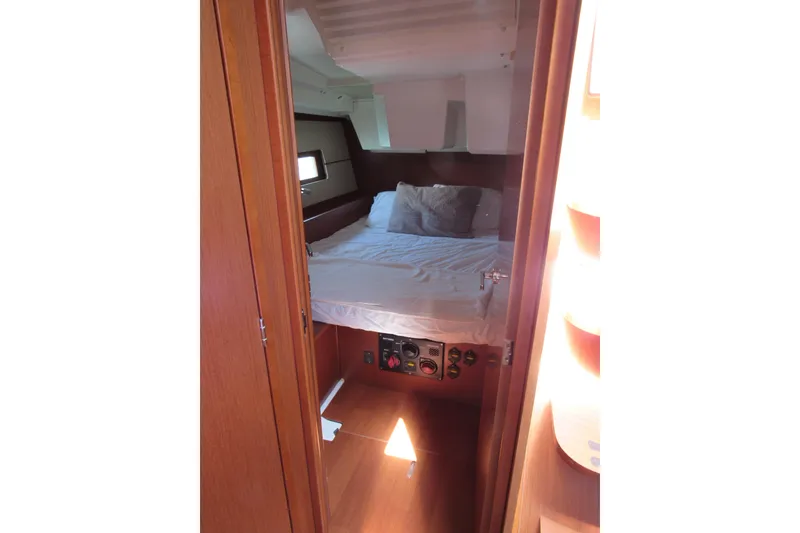 Slide: The Image of Interior cabin of 2020 Beneteau Oceanis 46.1 yacht with cozy bed and wooden finish. - 38