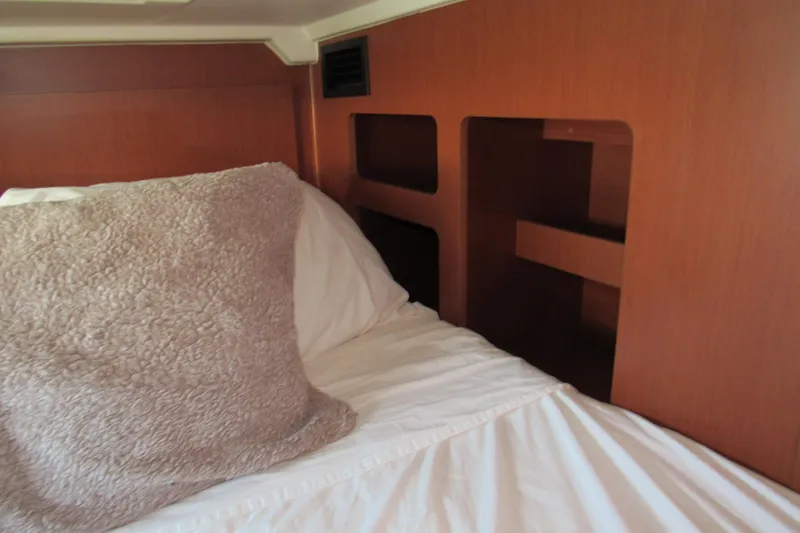 Slide: The Image of Cozy cabin interior of 2020 Beneteau Oceanis 46.1 with plush bedding and wooden accents. - 41