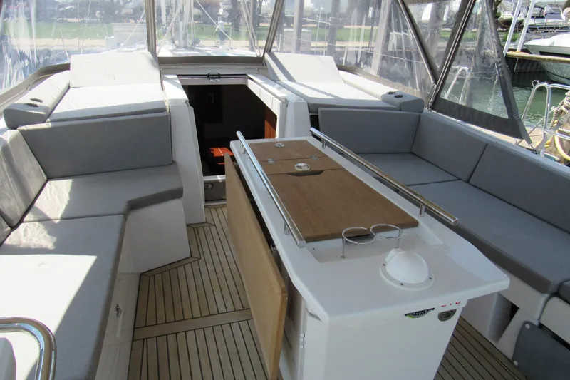 Slide: The Image of Spacious cockpit of 2020 Beneteau Oceanis 46.1 with comfortable seating and wooden table. - 47