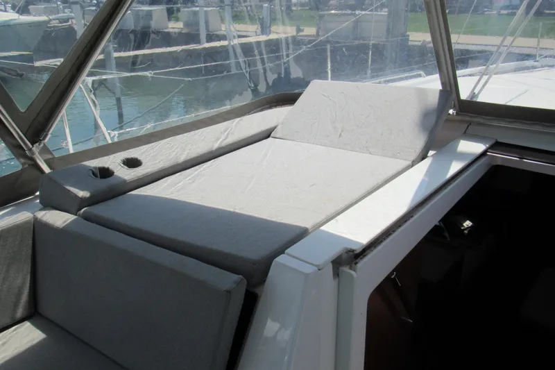 Slide: The Image of Beneteau Oceanis 46.1 (2020) cockpit with cushioned seating and cup holders. - 51