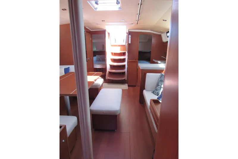 Slide: The Image of Interior of 2020 Beneteau Oceanis 46.1 yacht, featuring elegant wood finishes and cozy seating. - 52