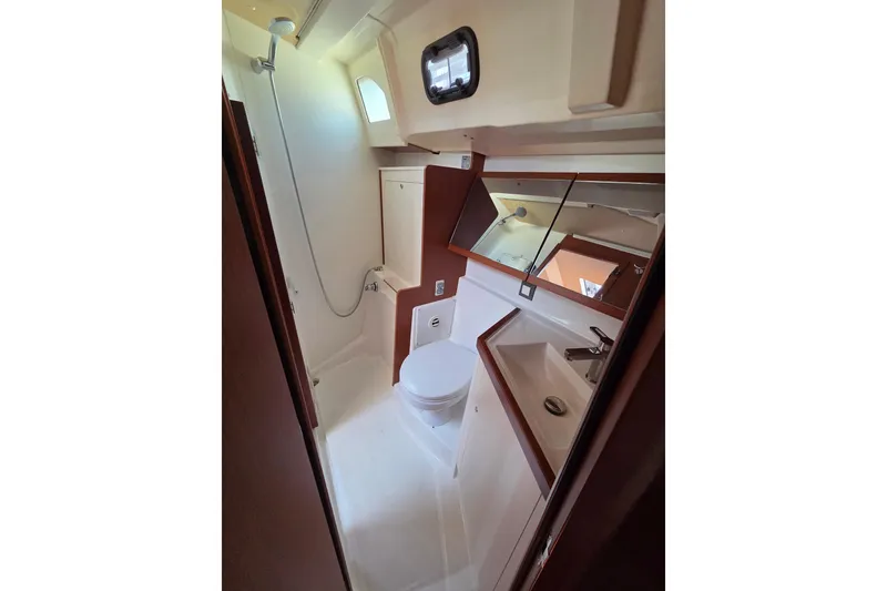 Slide: The Image of Bathroom interior of 2020 Beneteau Oceanis 46.1 yacht, featuring shower, toilet, and sink. - 58