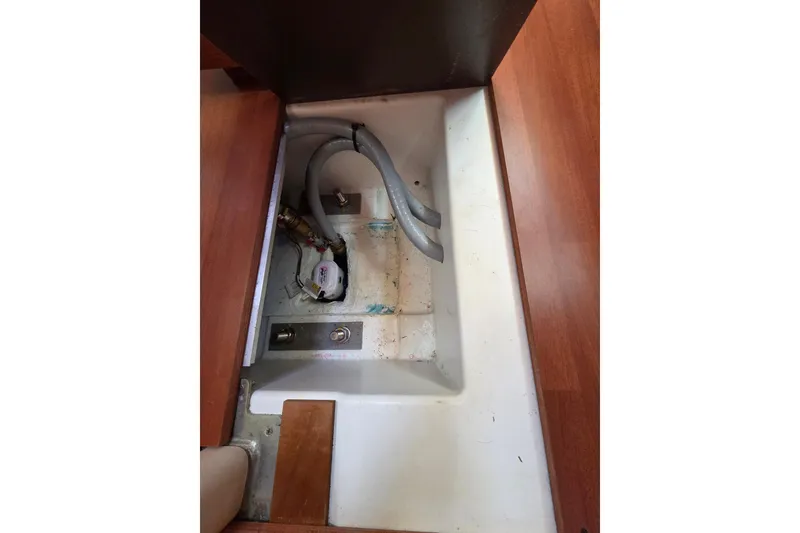 Slide: The Image of Bilge compartment of 2020 Beneteau Oceanis 46.1 sailboat, showing hoses and pump. - 59