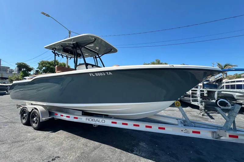 The Image of 2021 Key West 263 FS boat on a Robalo trailer, parked outdoors. - 0