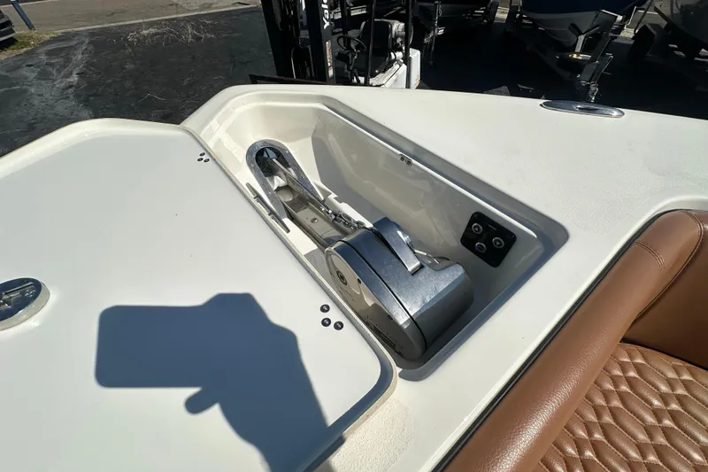 Slide: The Image of 2021 Key West 263 FS boat anchor compartment with control panel and cushioned seating. - 12