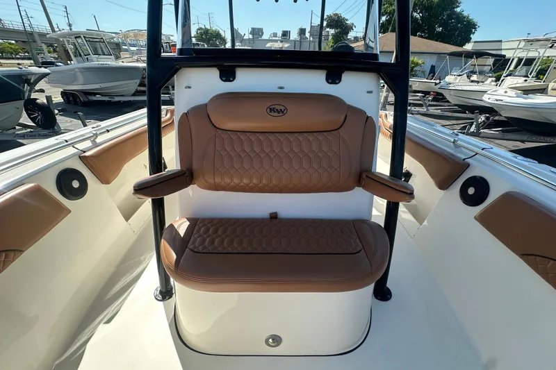 Slide: The Image of 2021 Key West 263 FS boat interior with tan seating and armrests. - 14