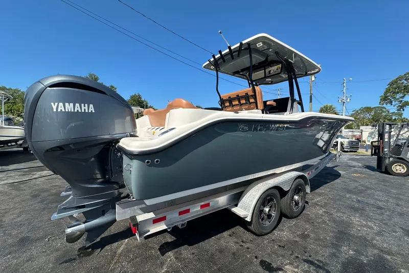 Slide: The Image of 2021 Key West 263 FS boat with Yamaha engine on trailer, sunny day. - 2